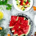 A colorful array of fresh fruit salad with watermelon and citrus, top view.