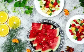 A colorful array of fresh fruit salad with watermelon and citrus, top view.
