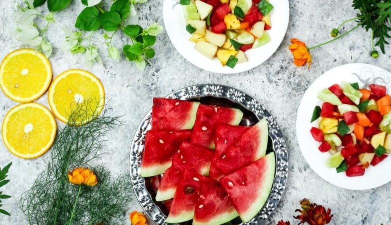 A colorful array of fresh fruit salad with watermelon and citrus, top view.